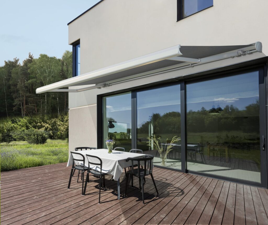 Large modern building with sliding doors and a Zenith retractable awning