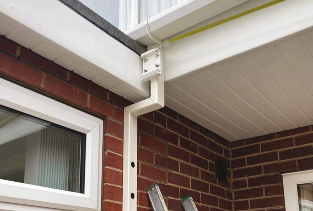 Close up of an awning bracket on a UK home made from red brick