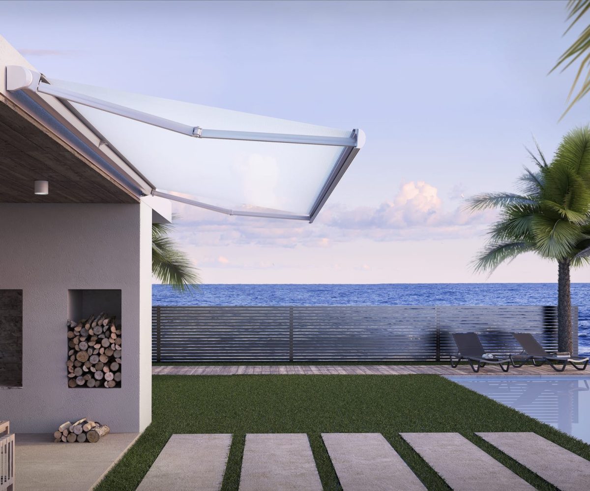 Seaside home with a view of the ocean and a white Base Plus fully cassetted awning